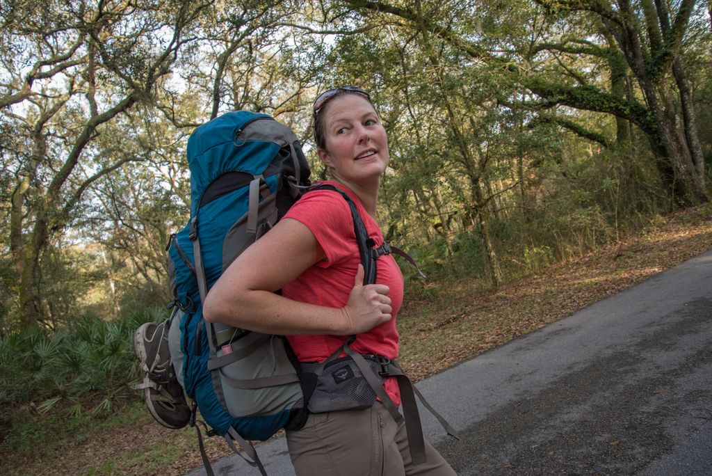 woman with backpack in forest