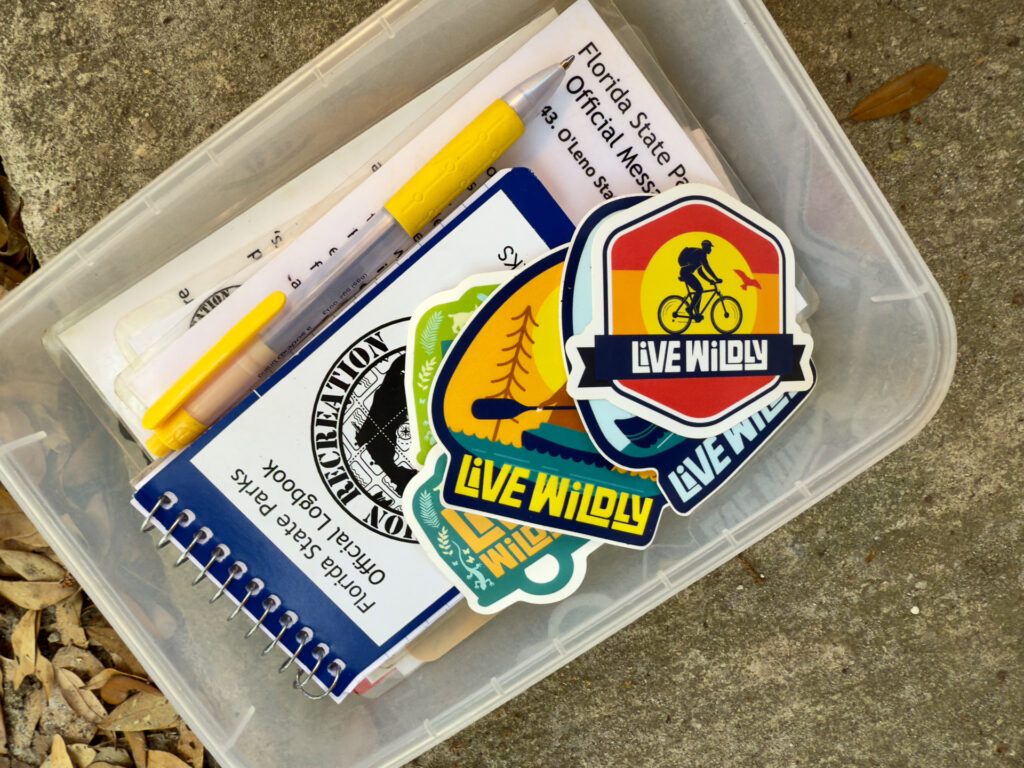 Florida State Parks logbook, pen, and "Live Wildly" stickers - Explore Wild Florida with These 6 Nature Apps